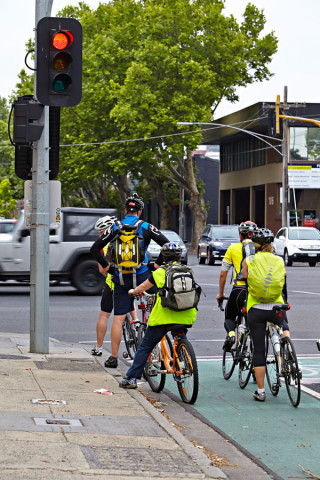 Cyclists waiting at the red lights